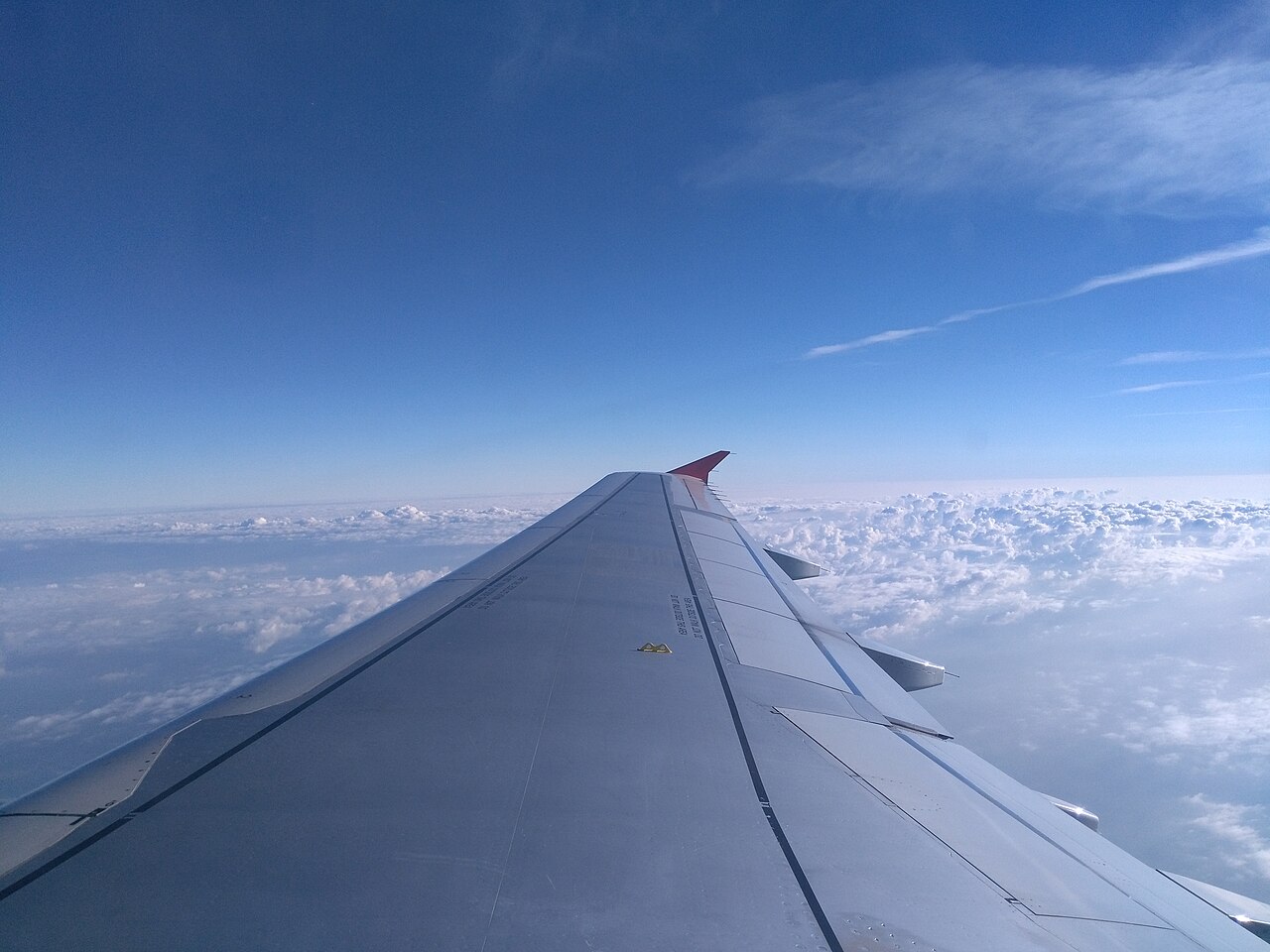 A wing above the clouds